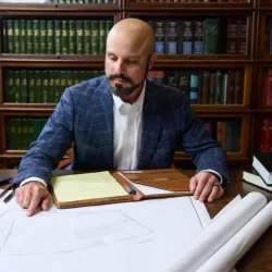 Mark Hines sitting at a desk working on an Estate Plan for a client