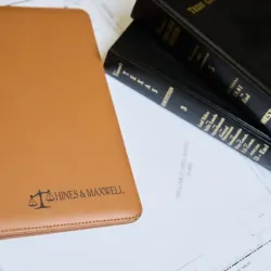 legal documents, business planner with the Hines Maxwell logo, and Texas legal code books